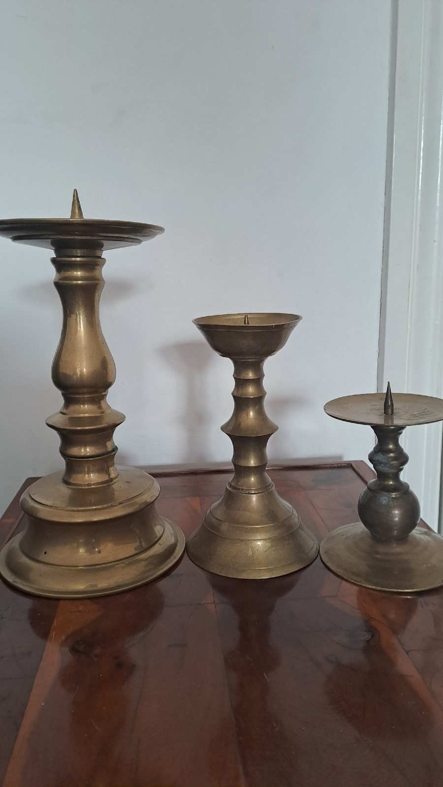 Vintage trio of brass pillar candle holders