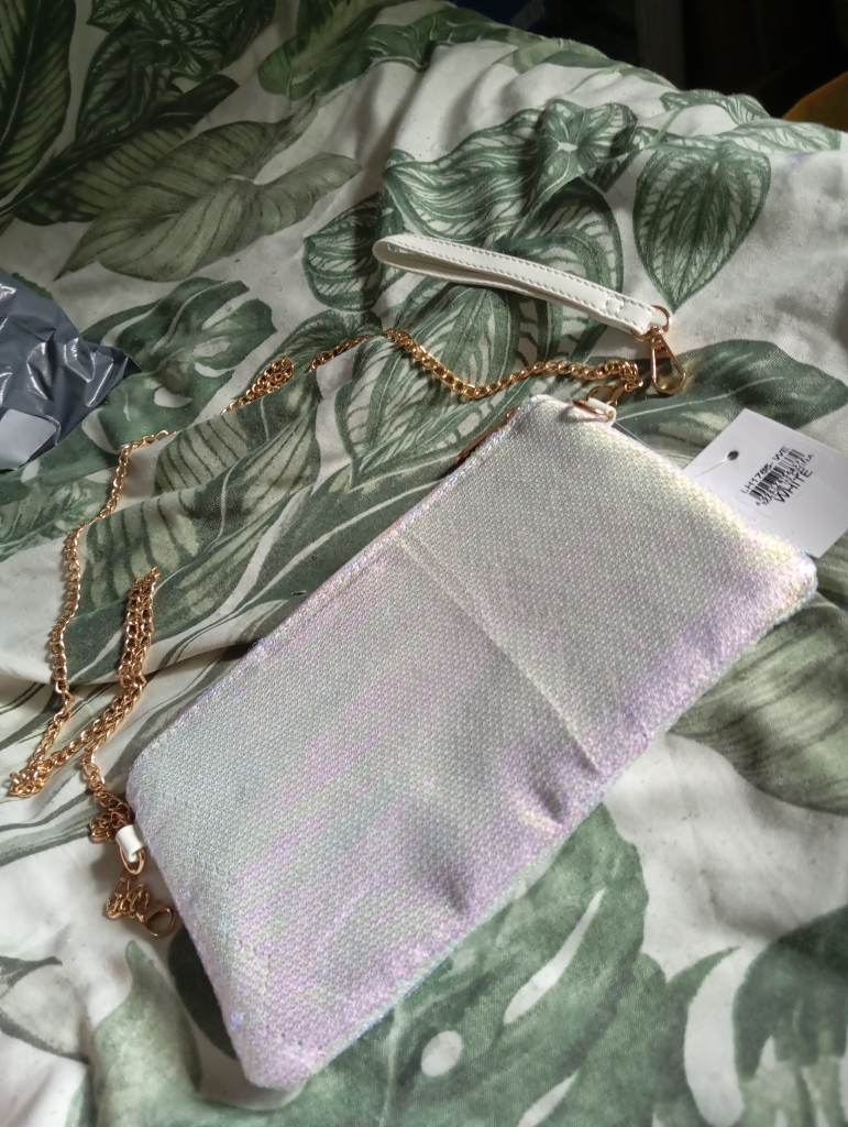 White with shimmers of pink and purple sequinned bag