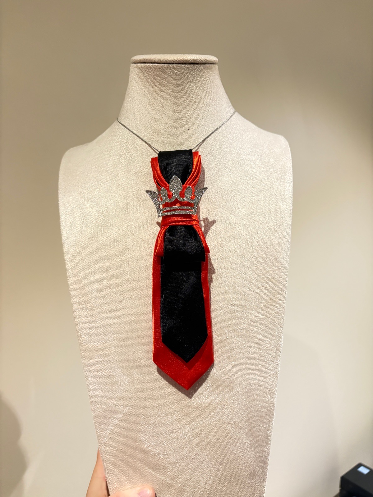 Black and red tie with brooch