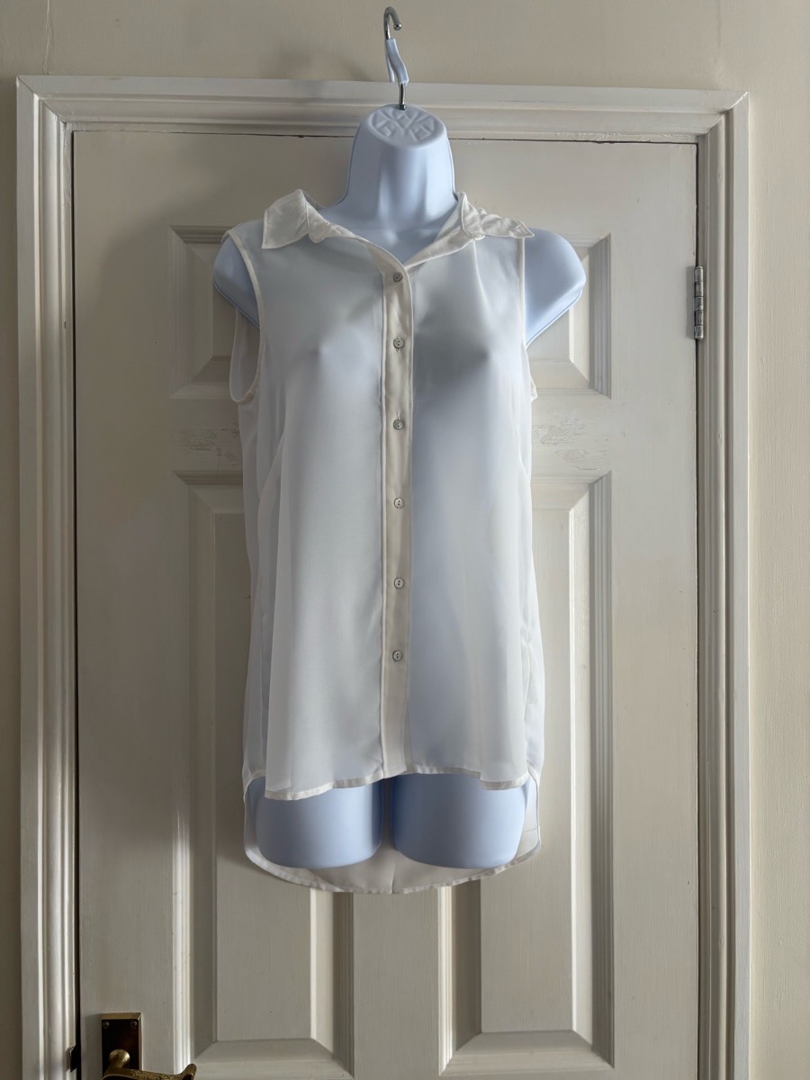 White sleeveless button up top