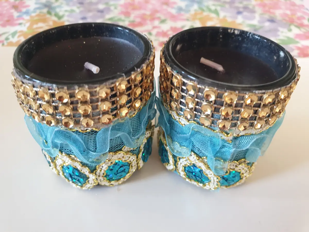 Handmade teal and gold beaded candle holders with blue lace and sequin embellishments.