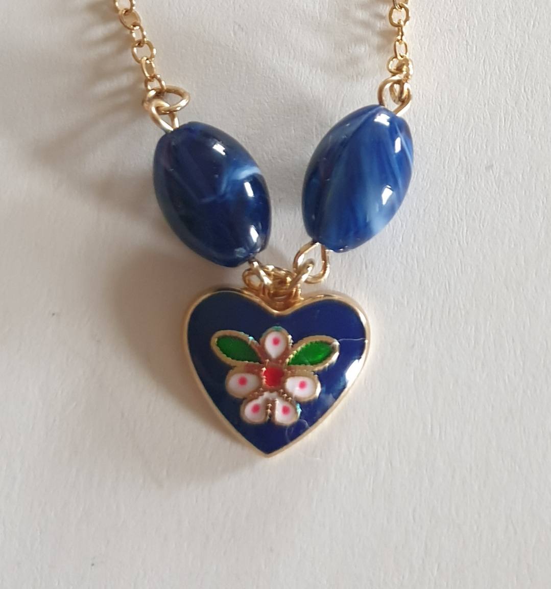 Blue heart necklace and earrings set features a floral design