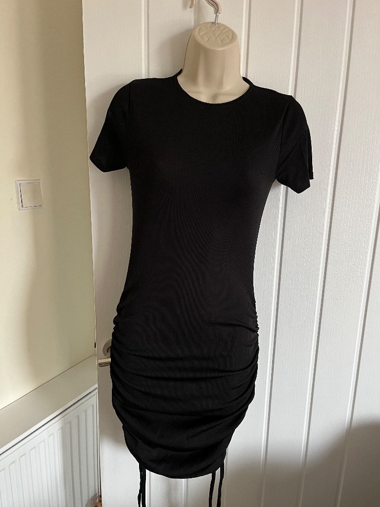Ladies black bodycon runched mini dress with side strings to adjust length size 8