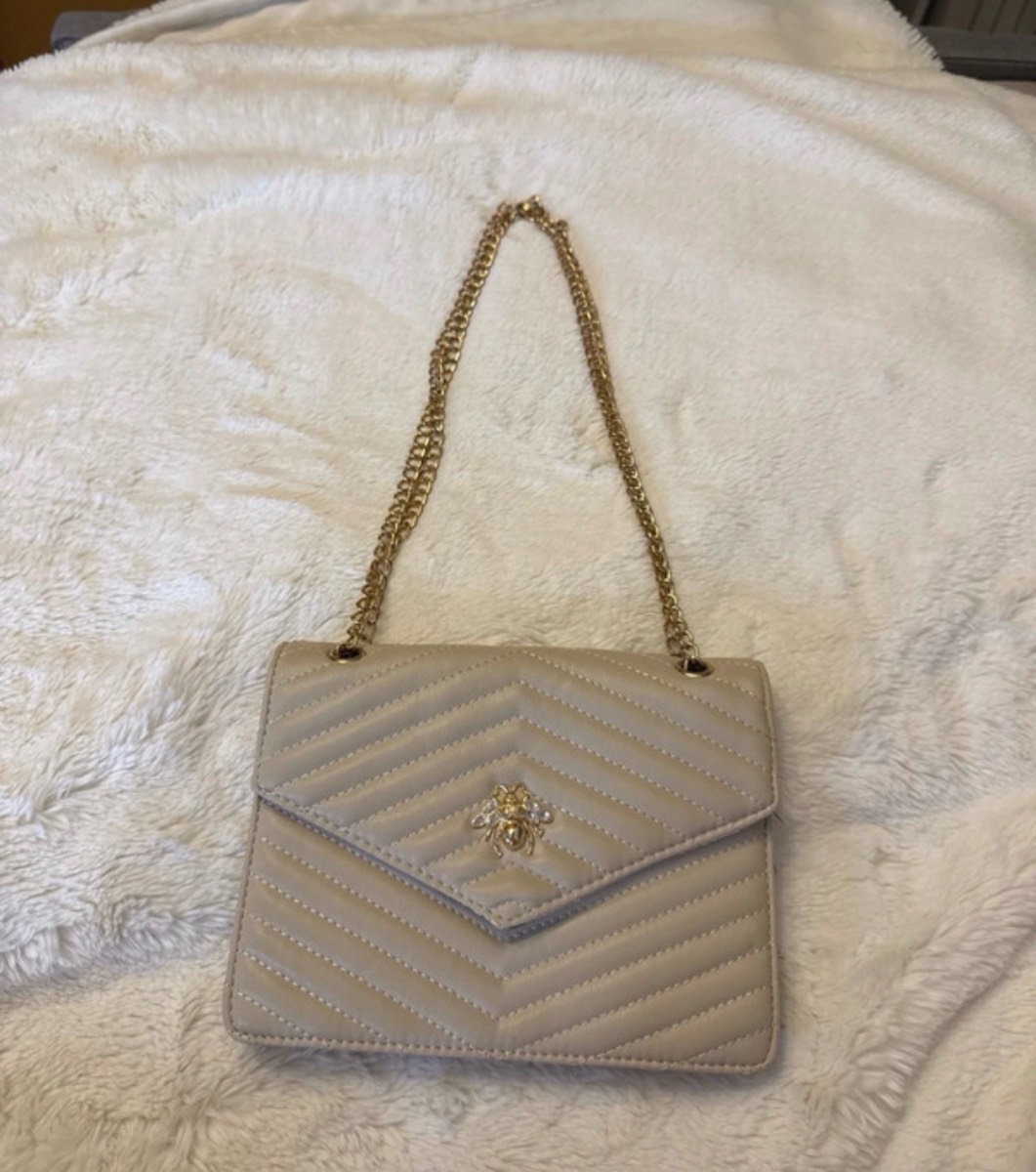 Beige new look bag with gold bee detail and gold chain straps