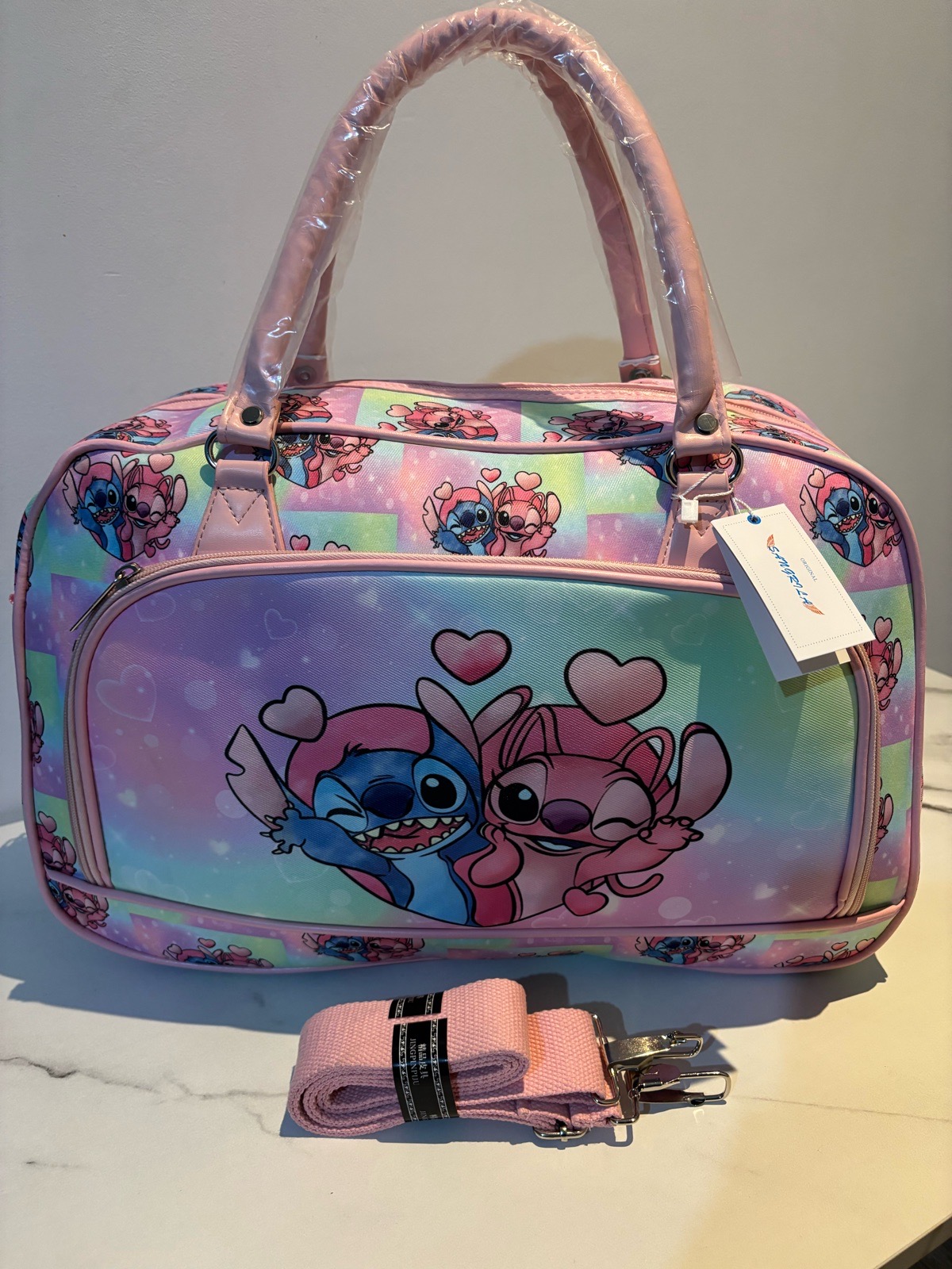Pink stitch character travel bag with shoulder strap