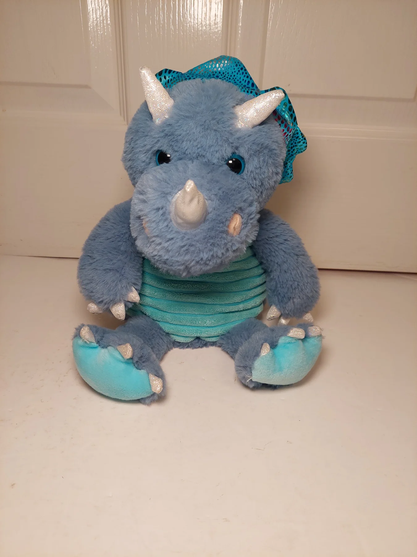Light blue dinosaur plush with removable heating bag 9"
