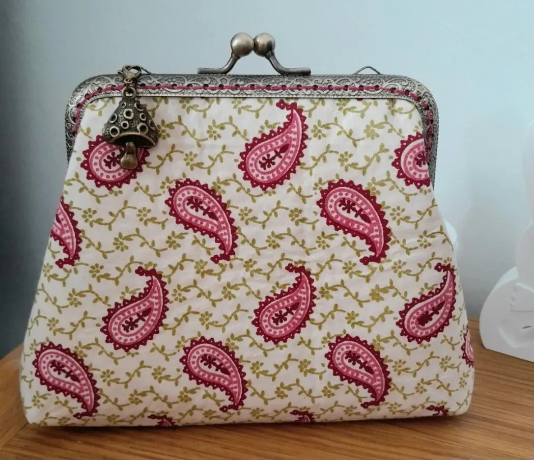 Vintage style handmade purse with decorative charm