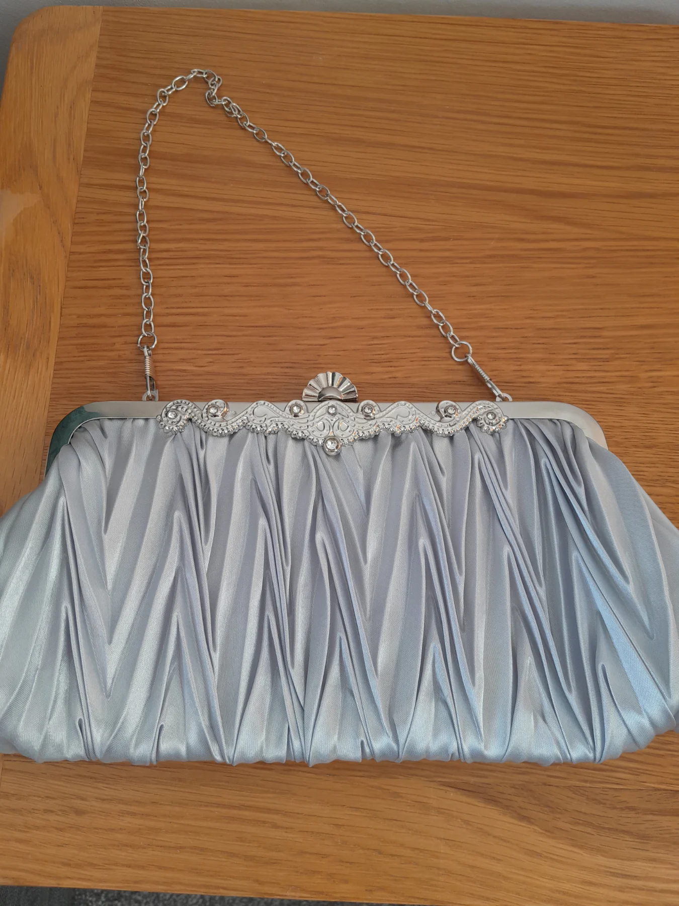 Silver clutch bag with detachable chain shoulder strap