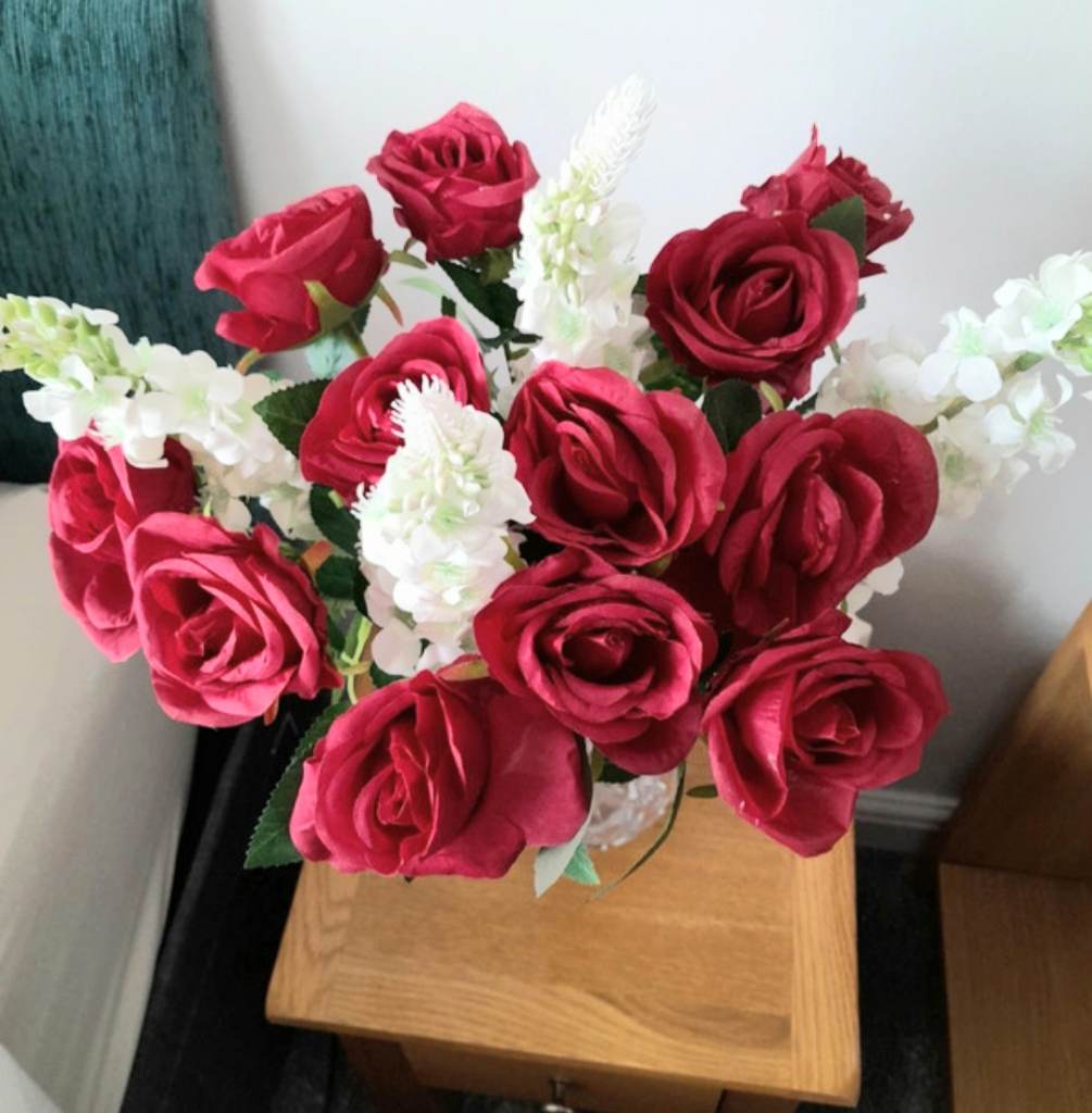 12 long stem red roses and 4 larkspur artificial flowers
