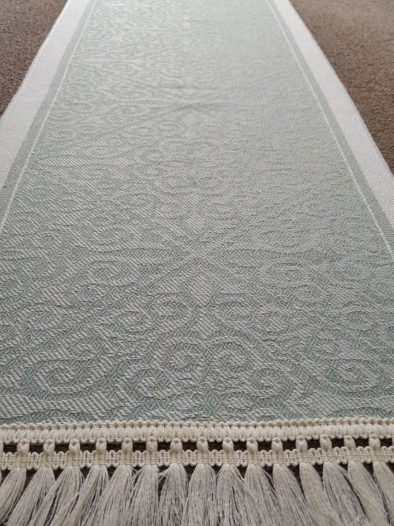 Geometric solid patterned table runner with tassels
