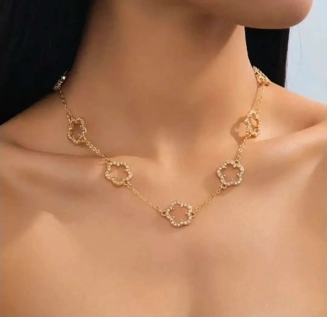 gold-toned necklace features delicate four-leaf clover charms.