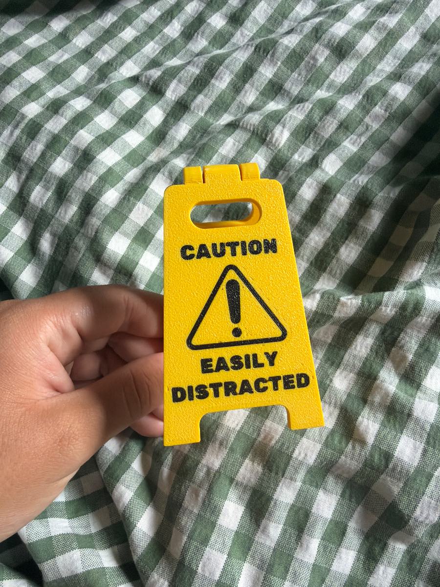 Caution easily distracted mini folding desk sign