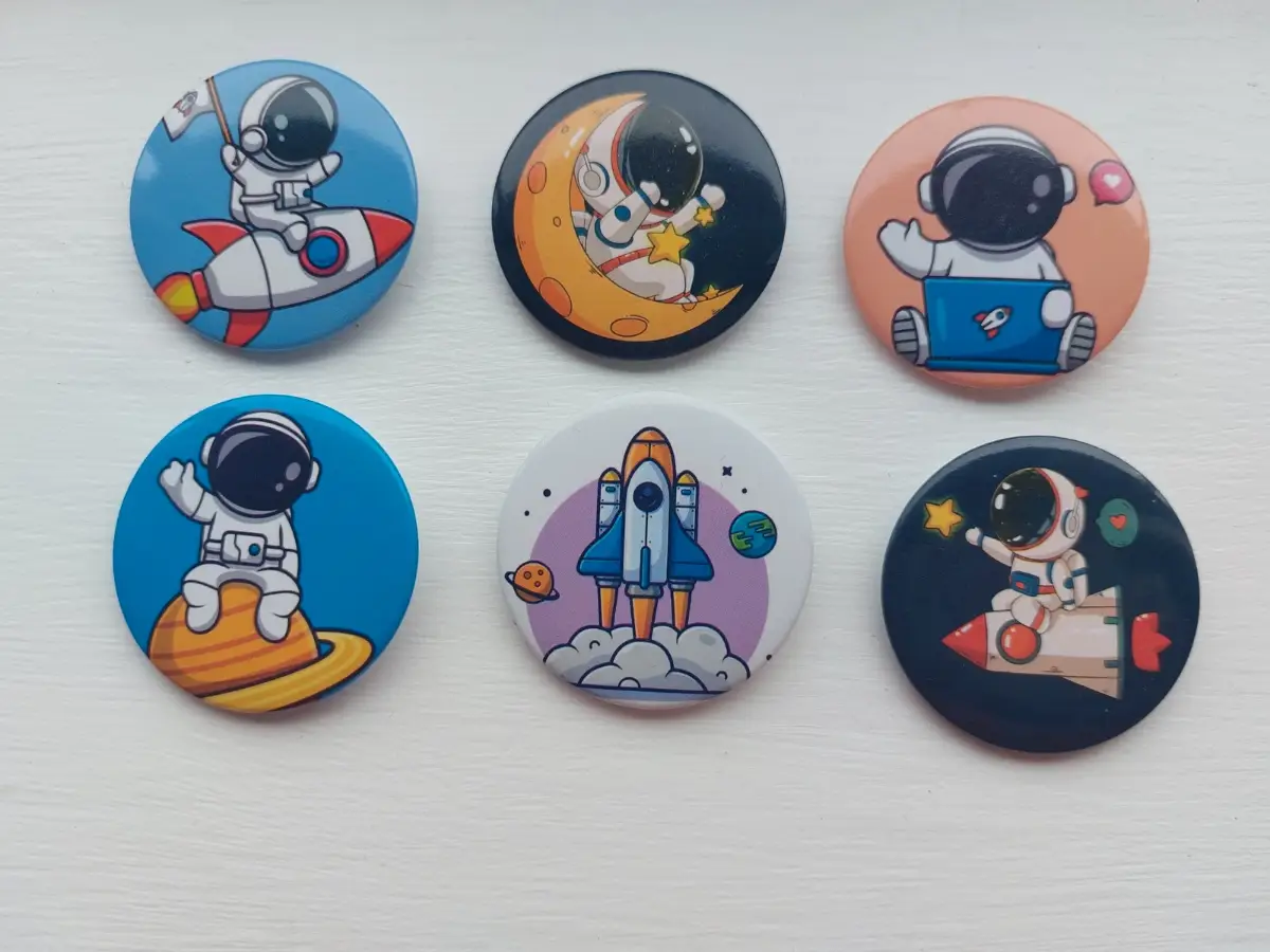 Six astronaut button badges colourful fun space themed designs