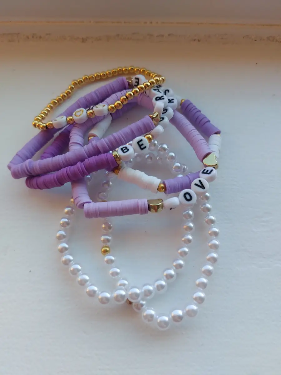 Seven purple and white friendship bracelets
