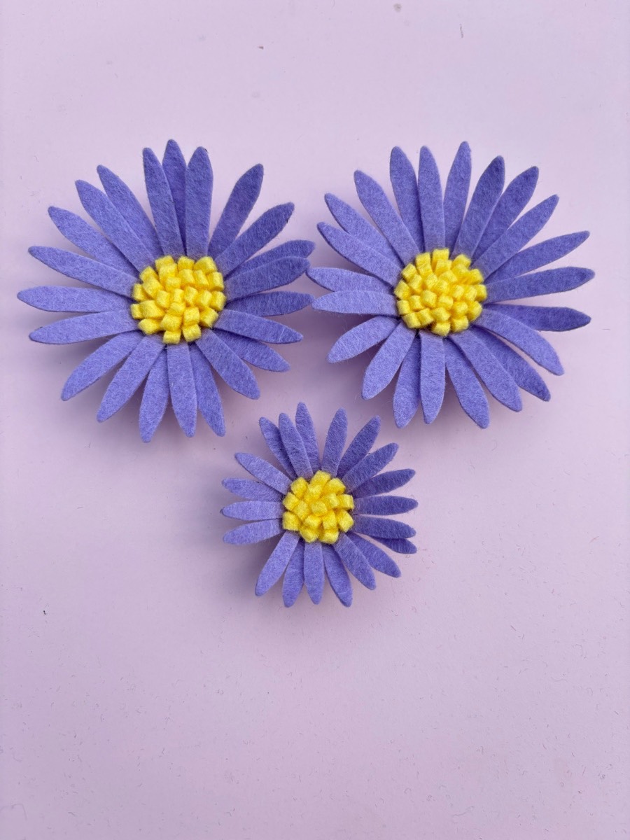 Three purple daisies.