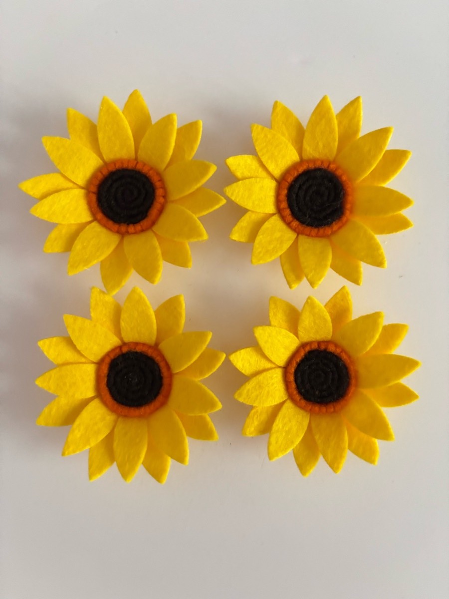Four small felt sunflowers