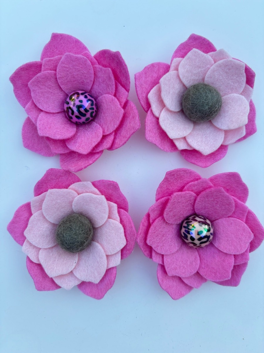 Four pink felt flowers