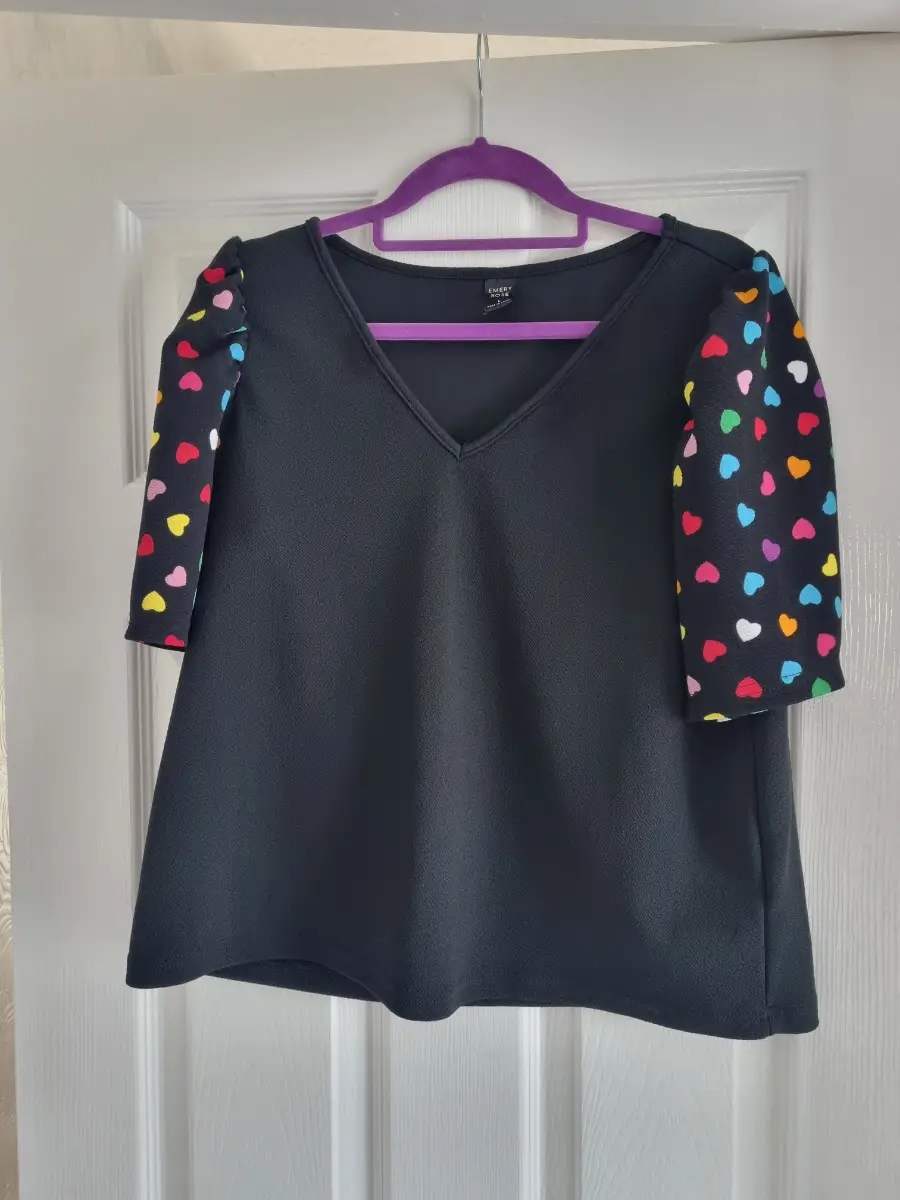 Black v neck top with poofy  heart patterned sleeves size L