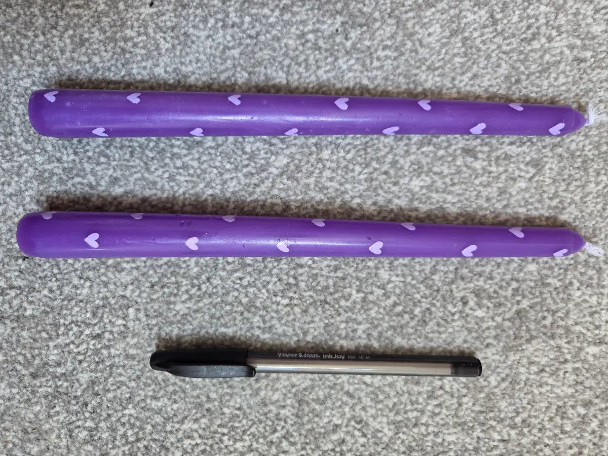 Dark purple taper candles with light purple hearts