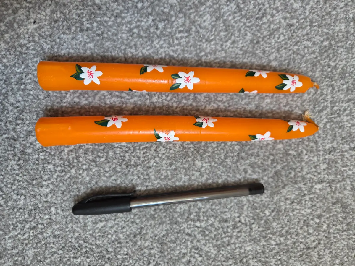 Orange taper candles with flowers
