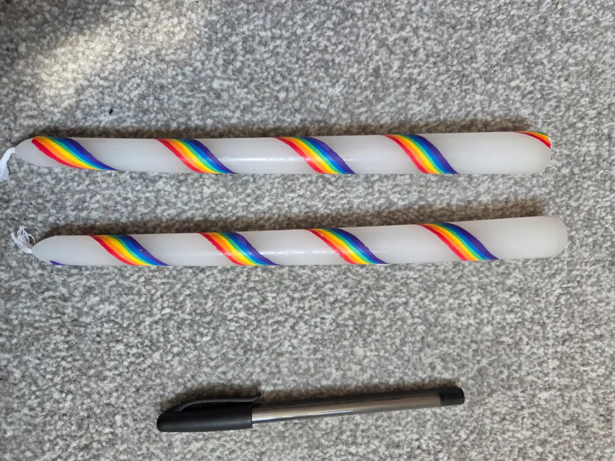 White taper candles with rainbows