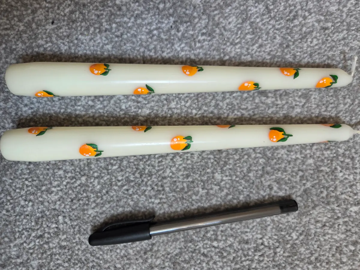 Taper candles with oranges