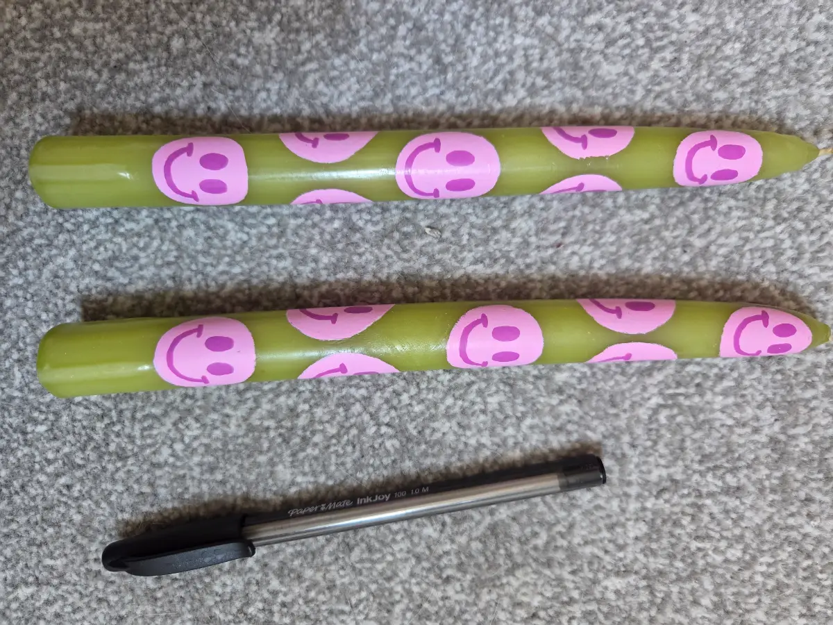 Green taper candles with pink smilies
