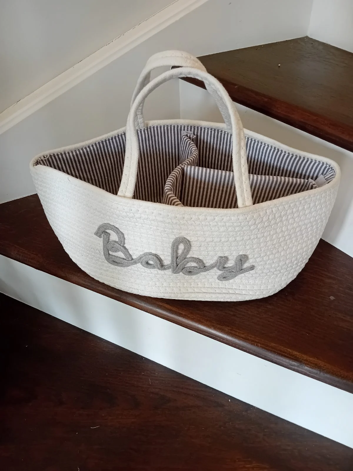 White woven baby nappy storage and essentials holder