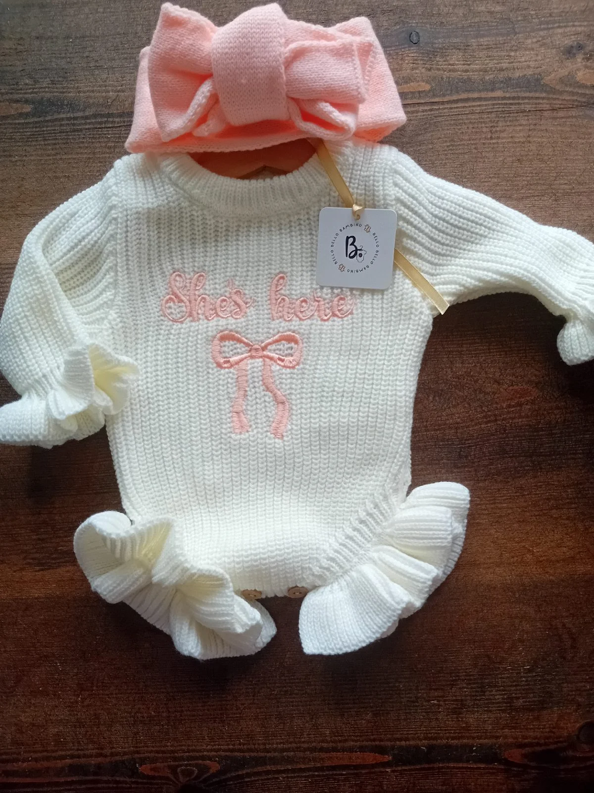 Girls 'she's here' knitted romper with oversized bow newborn