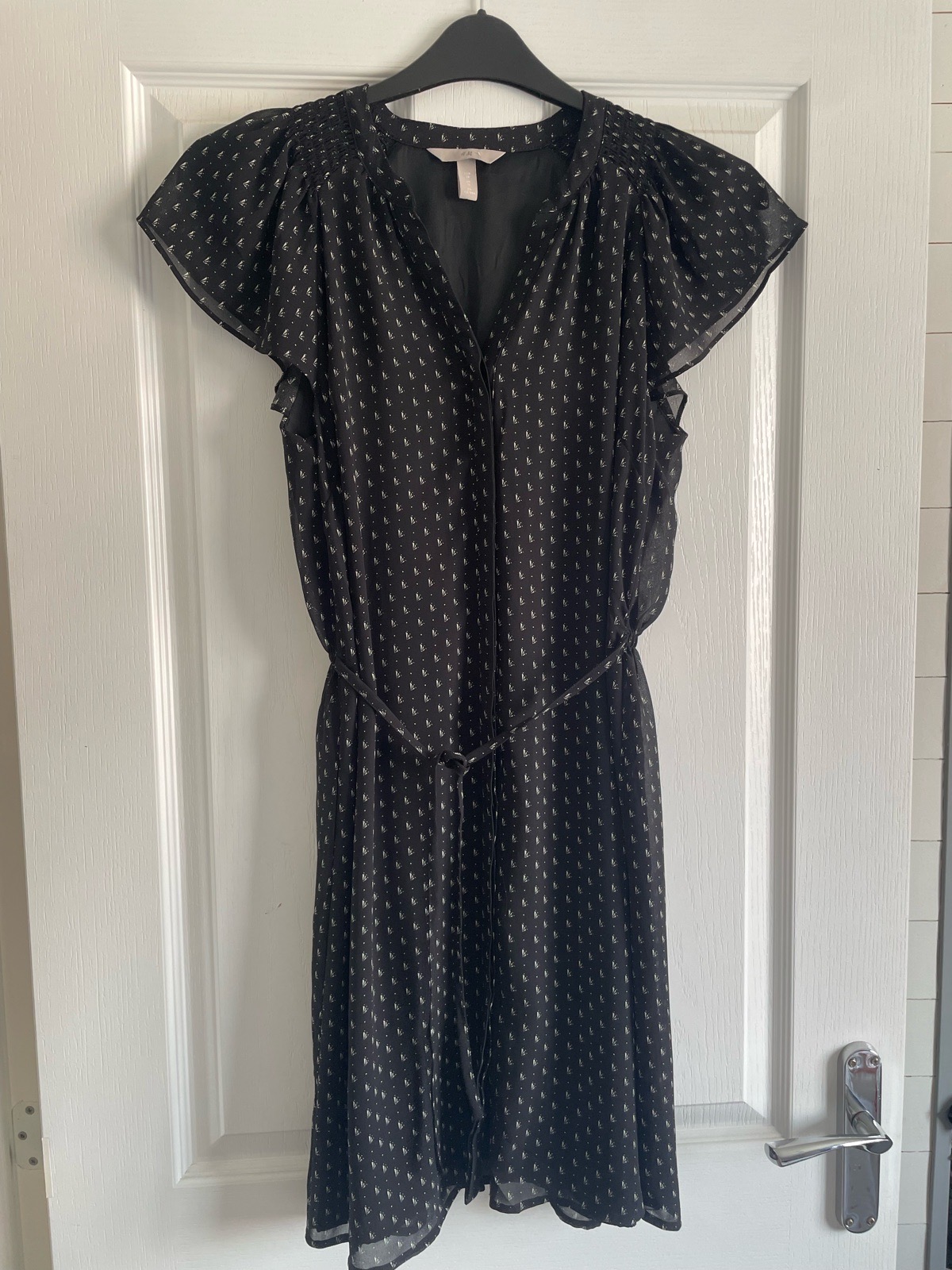 H&M black patterned midi dress with short flutter sleeves in size 10