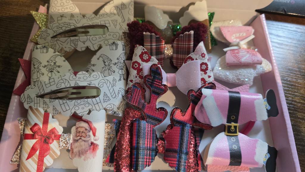 9 christmas bows and 2 fringe clips