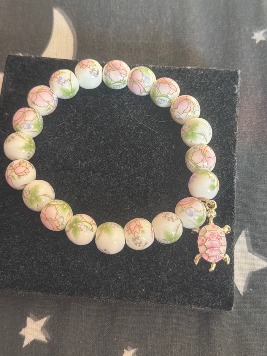 Handmade flower bracelet with turtle charm