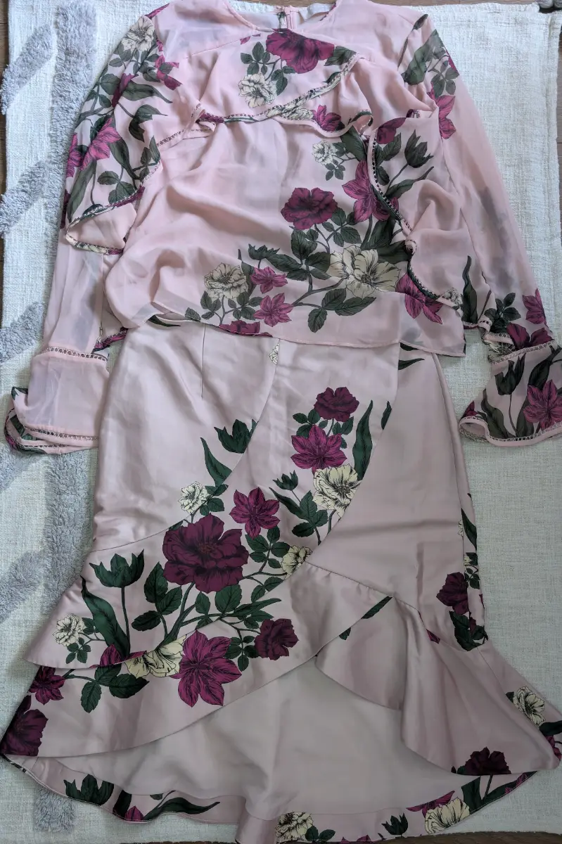Keepsake costume is light pink, with a large floral pattern, size XL