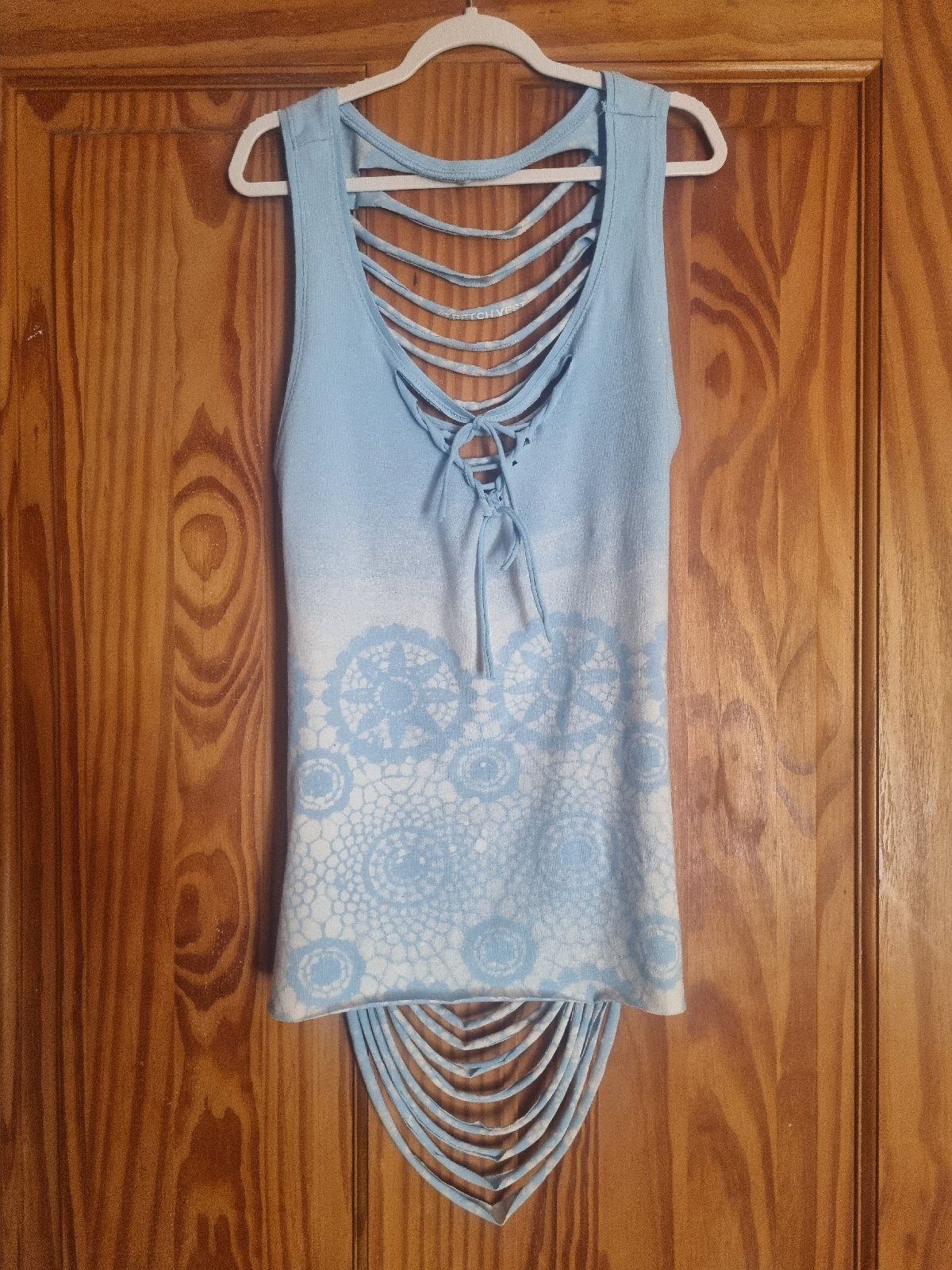 Baby blue, open backed vest