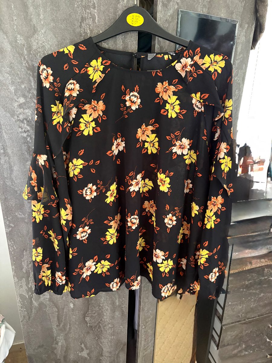Black blouse with long frill sleeves and floral print