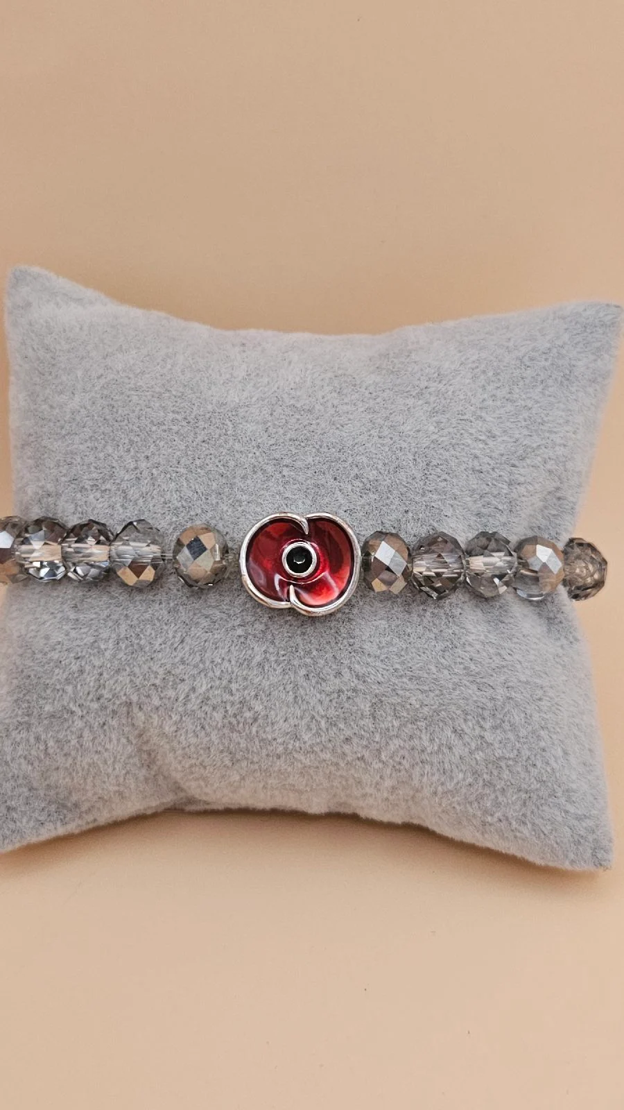 Beaded grey crystals elastic bracelet with poppy charm