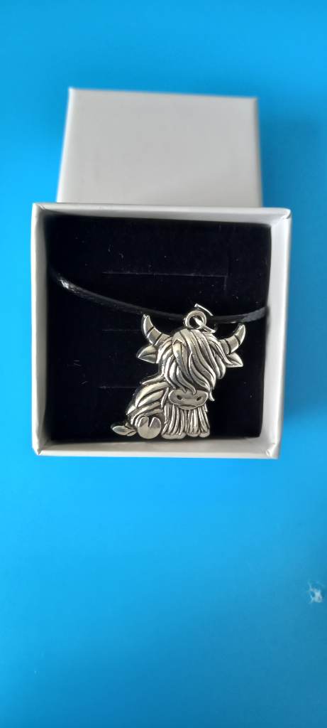 Silver Highland cow charm on black necklace